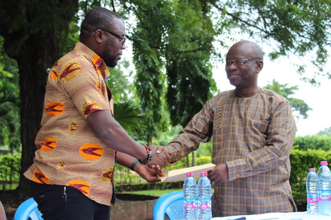 Chairman awards committee, Dr. Leonard Victor Amengor, presenting the final report to Chairman of the Brong Ahafo Regional GJA Larry Paa Kwesi Moses