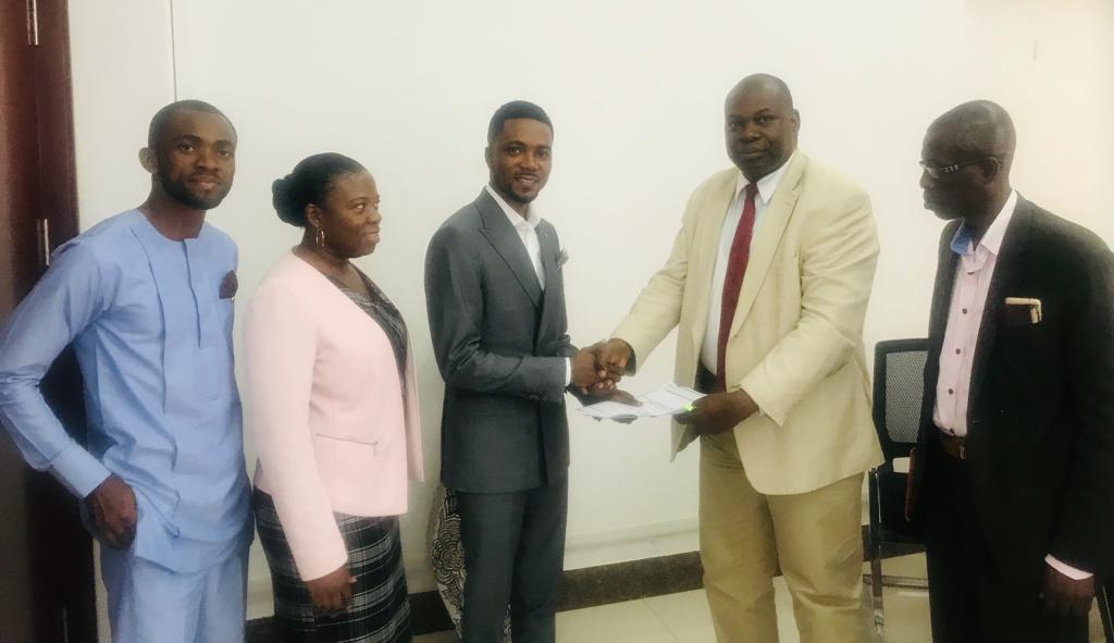 Professor Seth Owusu-Agyei (Pro-Vice-Chancellor) handing over documents to Mr Rudolf Schirmer Ampofo-Domfeh, founder and CEO of Augson Global